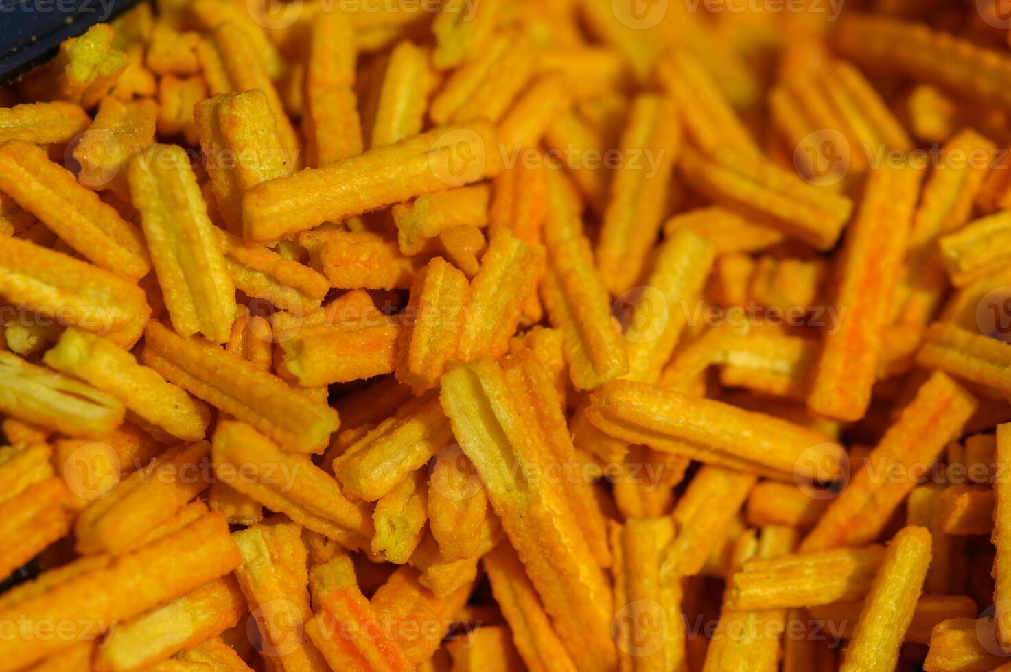 Crunchy yellow snacks displayed at a local market during a vibrant afternoon gathering with friends and family photo