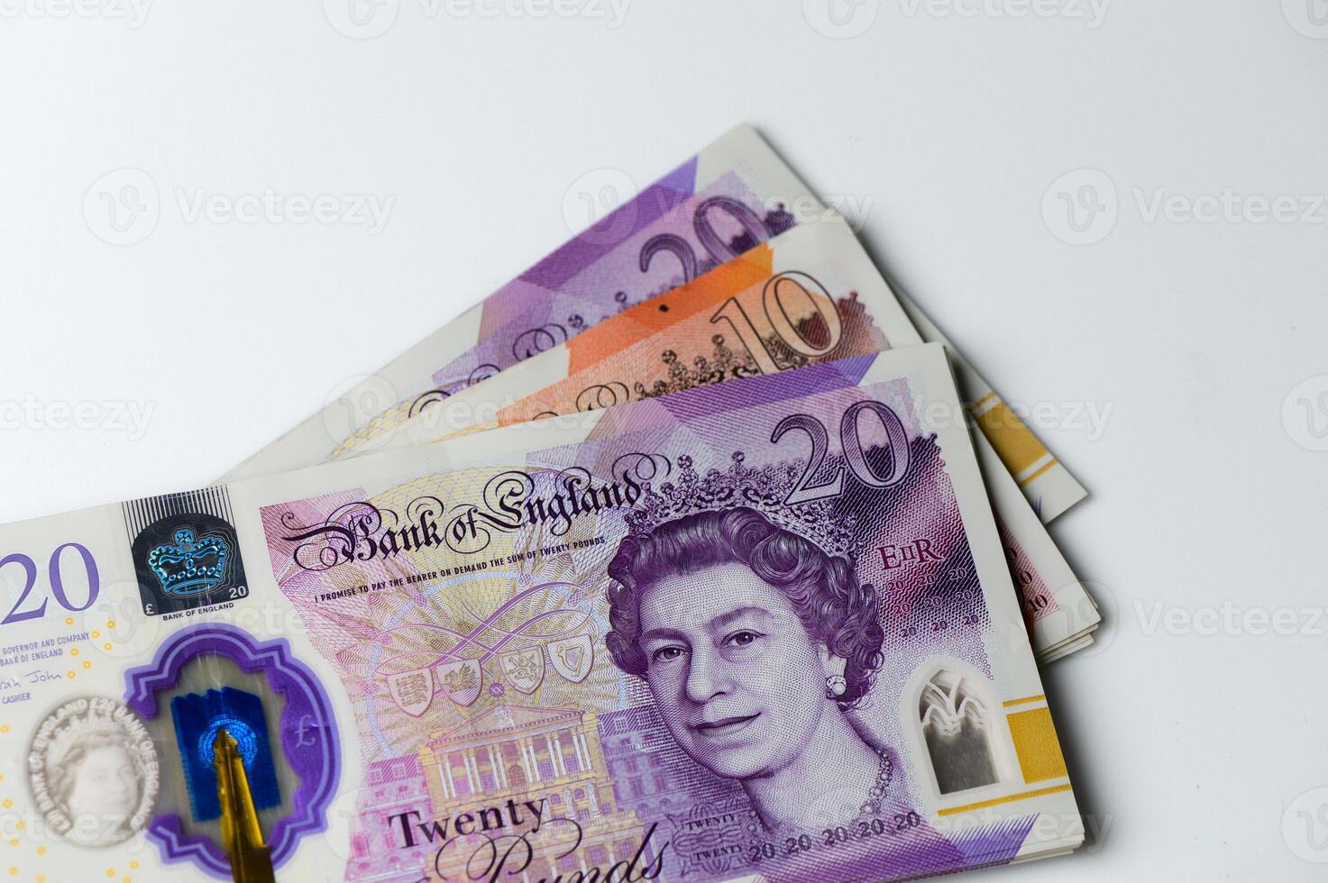 Colorful banknotes featuring royalty arranged artfully on a white surface evoke thoughts of finance and value in everyday life photo
