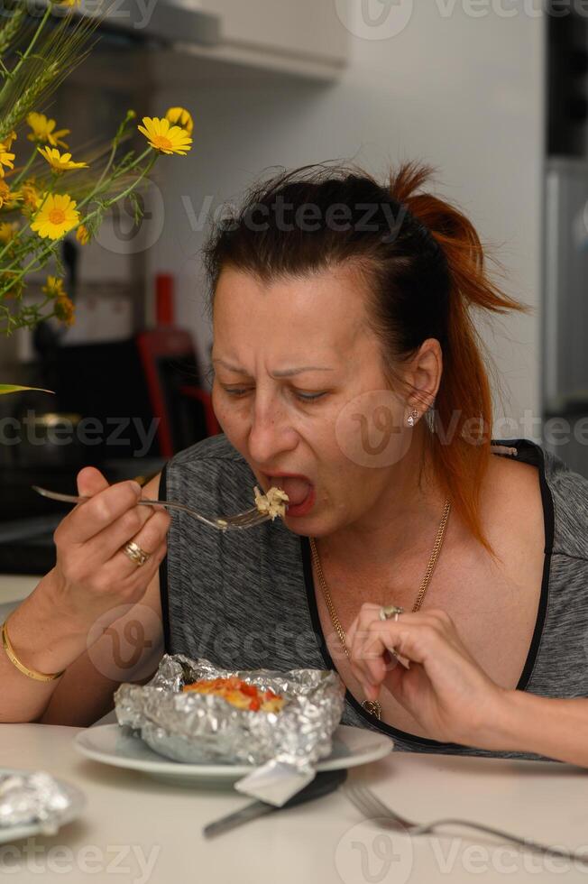 Enjoying a delicious meal at home, savoring every bite while surrounded by warmth and vibrant flowers photo