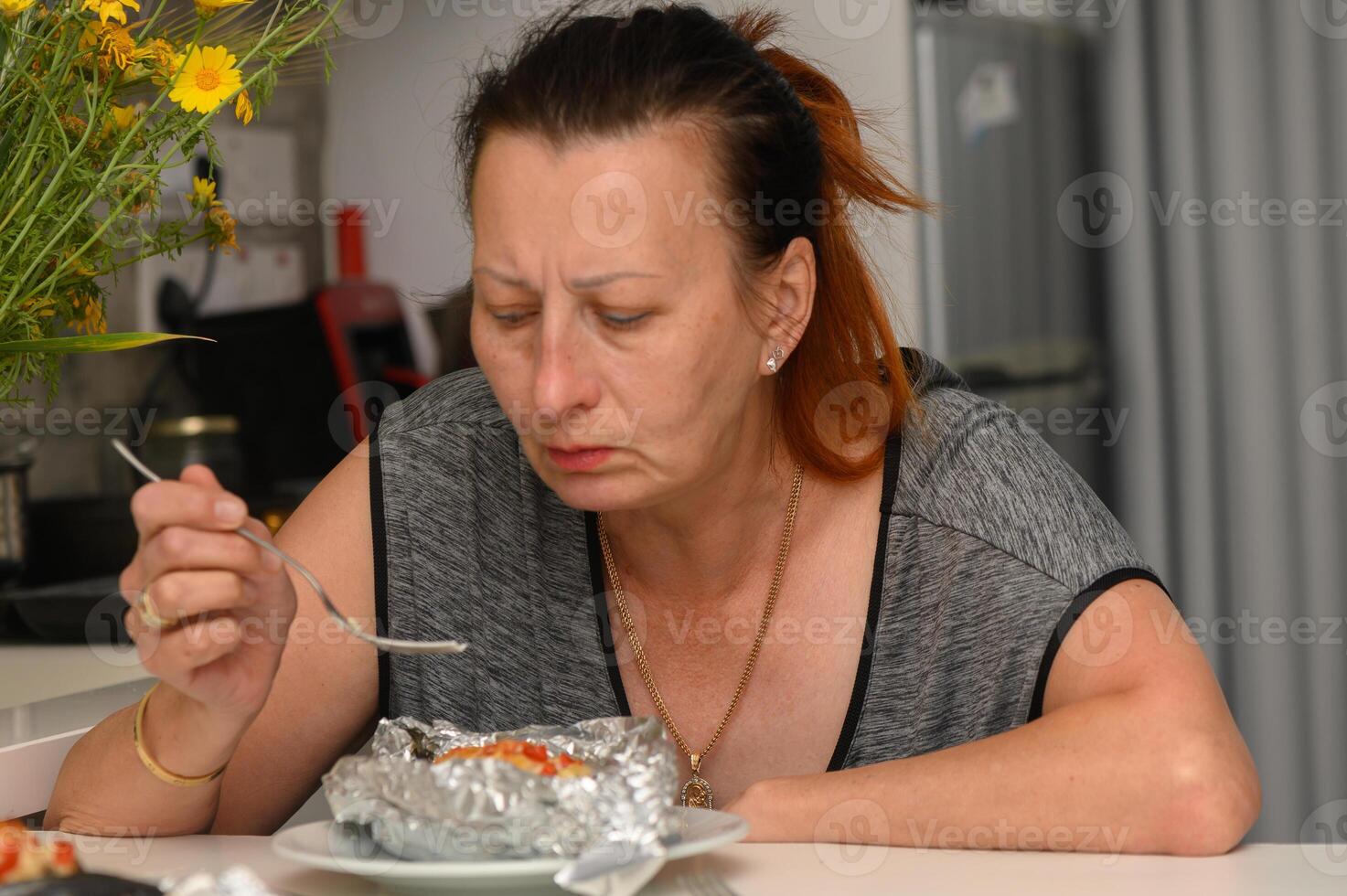 Enjoying a homemade dish at the kitchen table, showcasing moments of culinary delight and personal reflection during dinner time photo