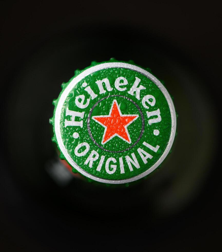 Gaziveren Cyprus -24.03.2025 heineken beer Refreshing drink topped with a bright green bottle cap showcasing a classic star emblem in a cozy gathering setting photo
