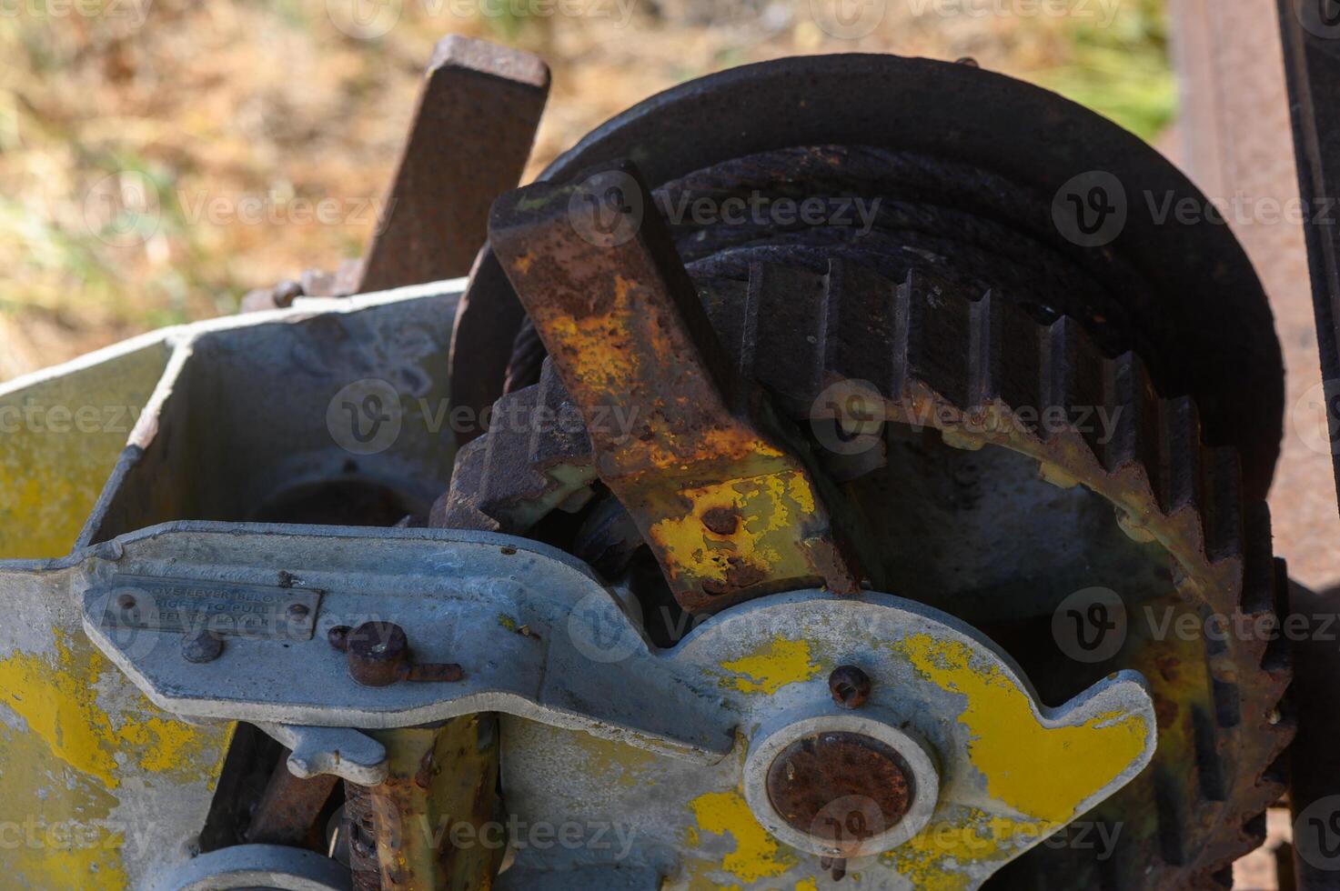 Exploring the intricate mechanisms of vintage agricultural machinery at a rustic farm in late summer photo