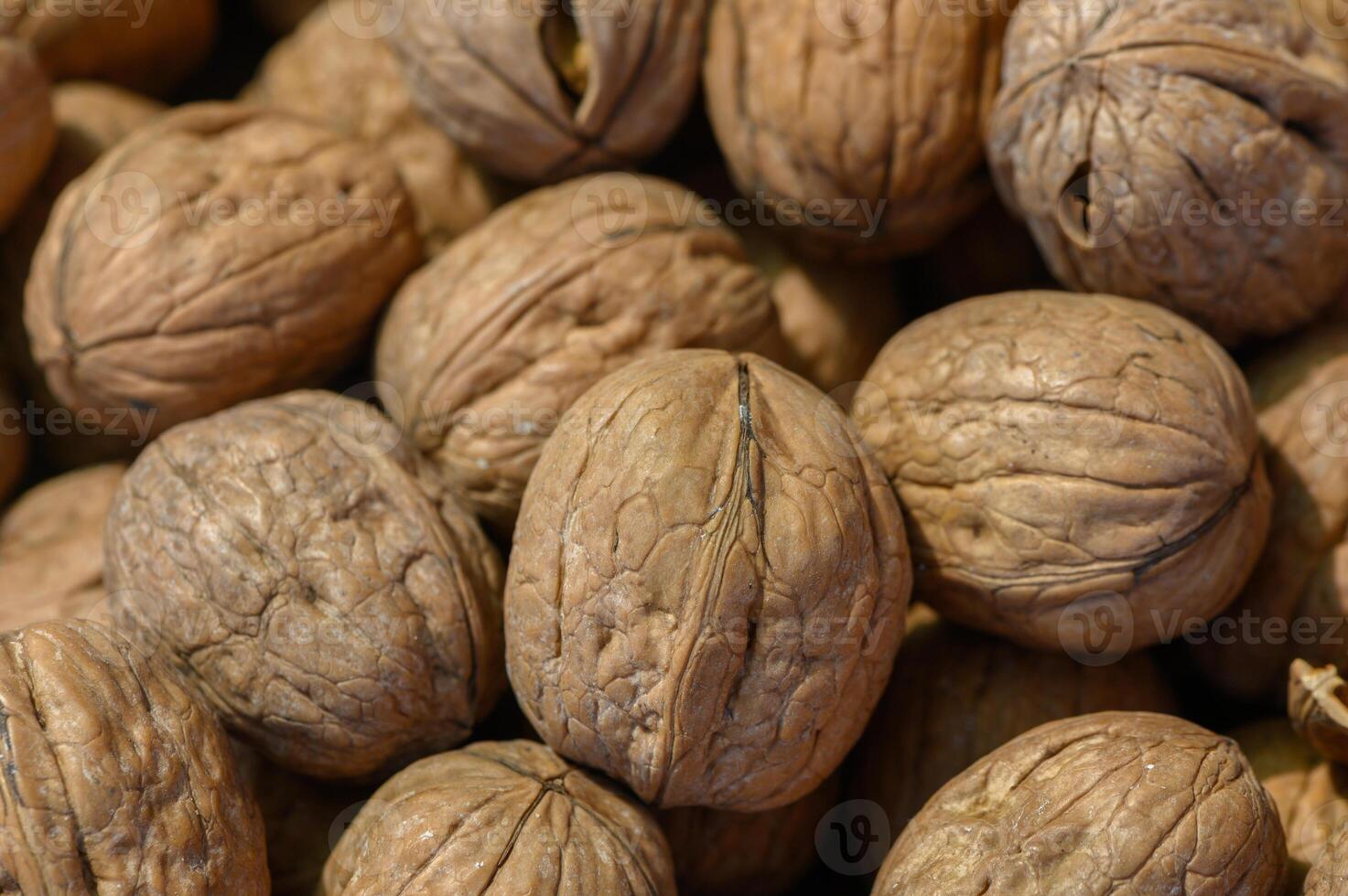 Nuts scattered across a wooden surface in a warm, inviting kitchen setting create a cozy atmosphere celebrating natural bounty photo