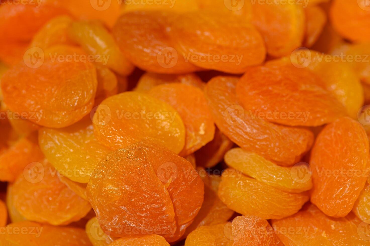 Dried apricots arranged in a colorful display showcasing their vibrant hues and natural texture during an artisanal market event photo