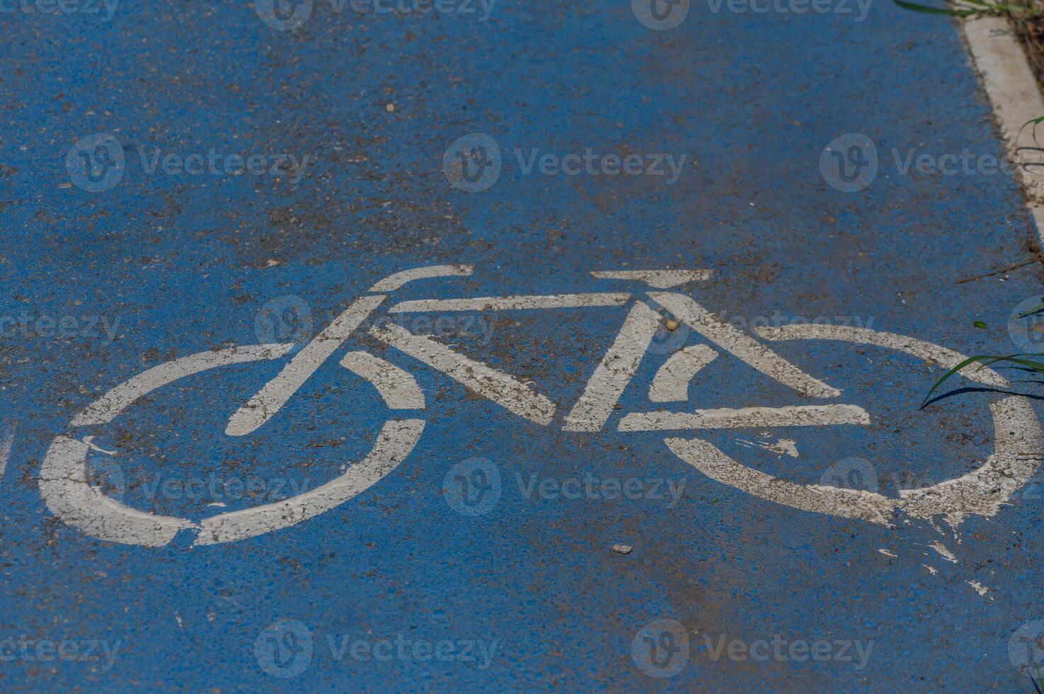 Bicycle symbol painted on a vibrant blue path signifies a welcoming space for cyclists in the city photo