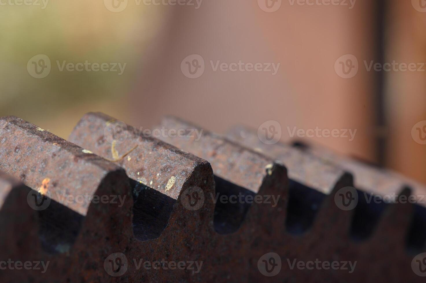 Intricately designed metal gears catching sunlight in a rustic workshop during the late afternoon photo