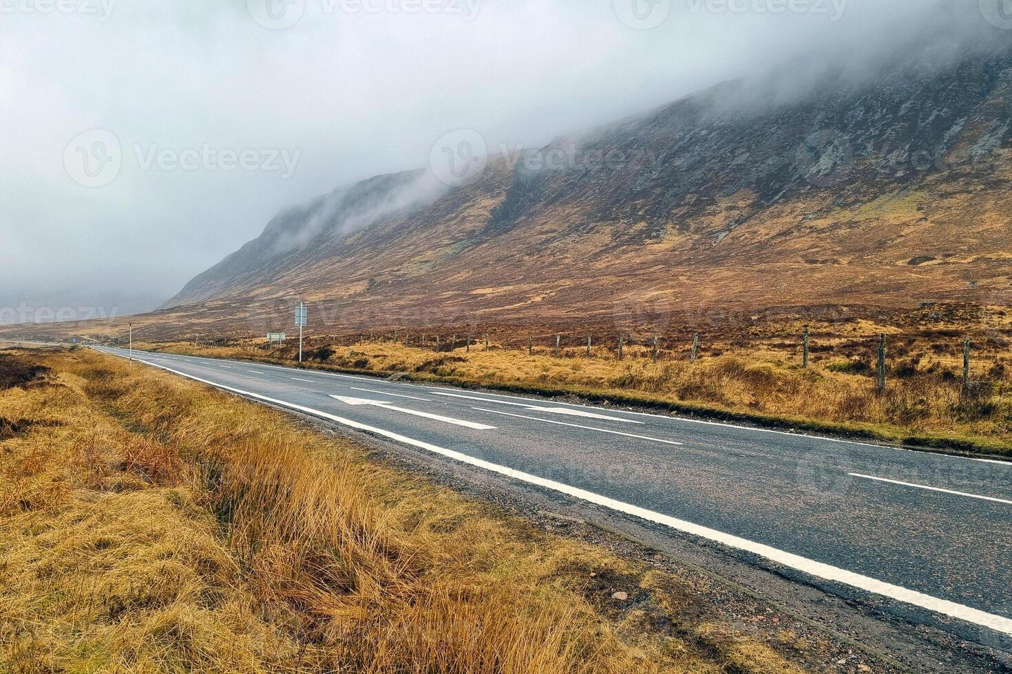 Misty Mountain Road Serene Landscape of Rolling Hills and Open Highway photo