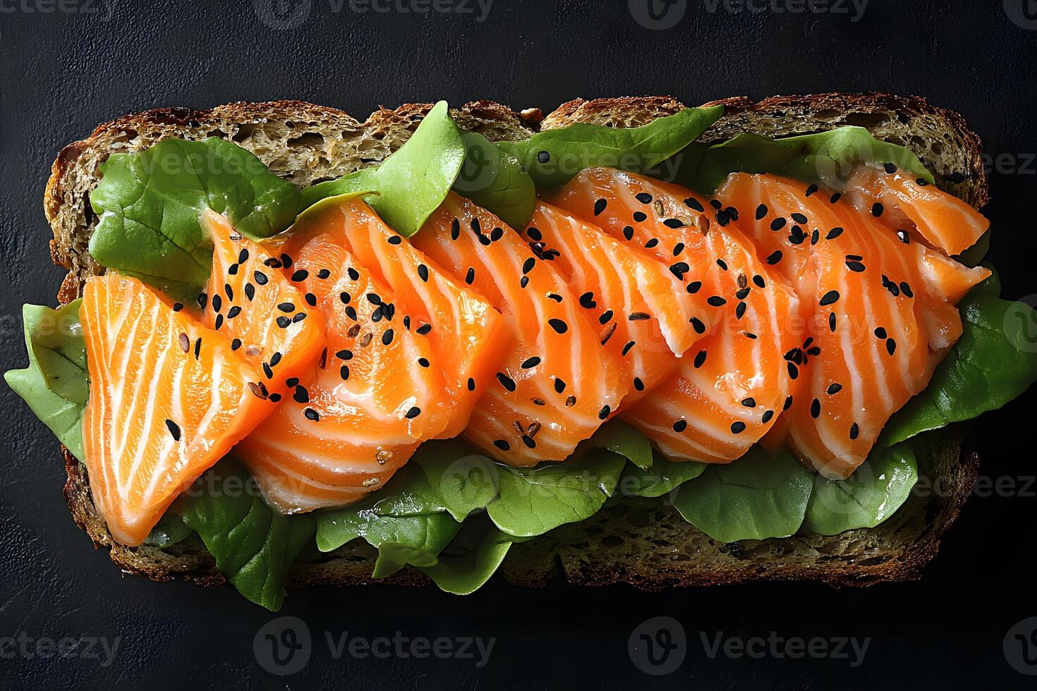 Gourmet Open-Faced Salmon Sandwich with Fresh Lettuce and Seeds on Dark Rye Bread photo