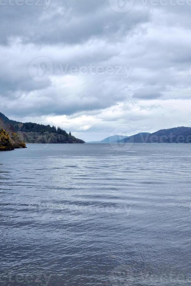 Scenic Overcast Landscape of a Tranquil Lake with Mountainous Horizon for Nature Photography photo
