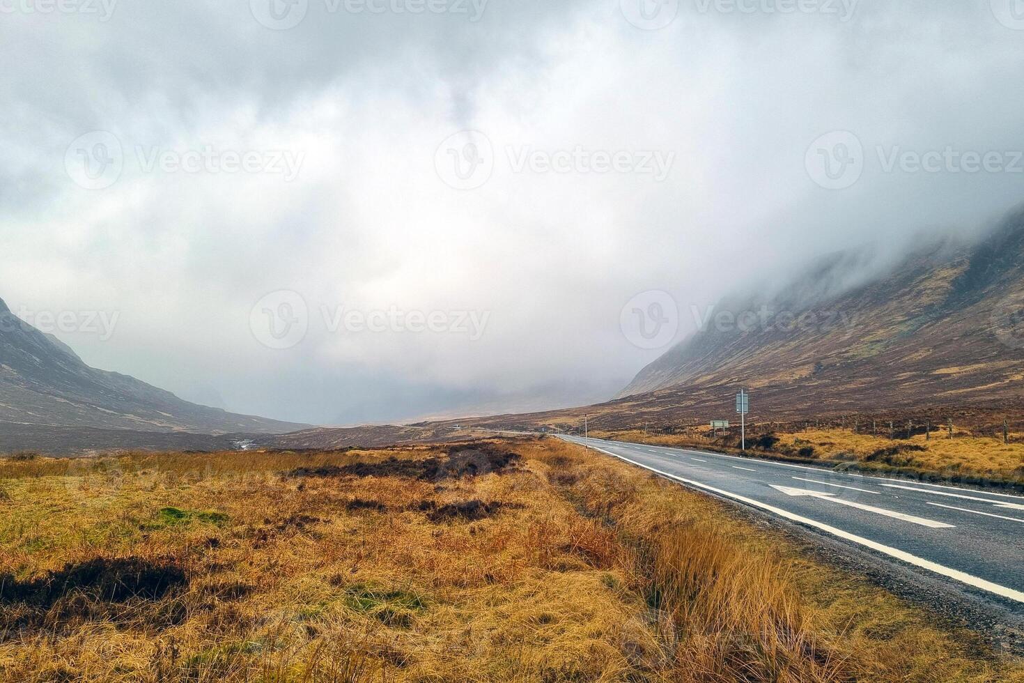 Moody Highland Landscape with Misty Hills and Open Road for Travel Inspiration photo