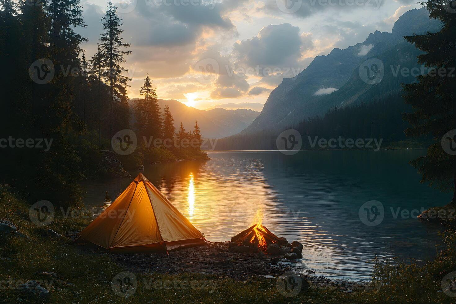 Tranquil Lakeside Camping at Sunset with Glowing Campfire in Scenic Mountain Landscape photo