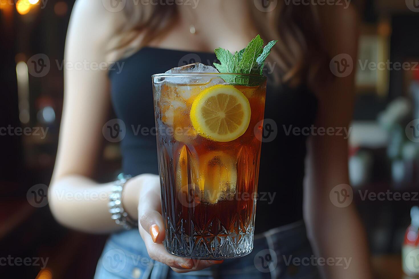 Refreshing Iced Tea with Lemon and Mint in a Crystal Glass for Beverage Promotions photo