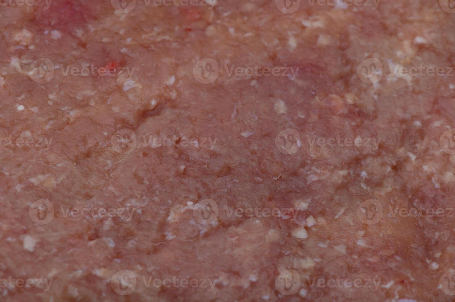 Richly textured ground meat displayed on a cutting board in a cozy kitchen setting during afternoon preparation photo