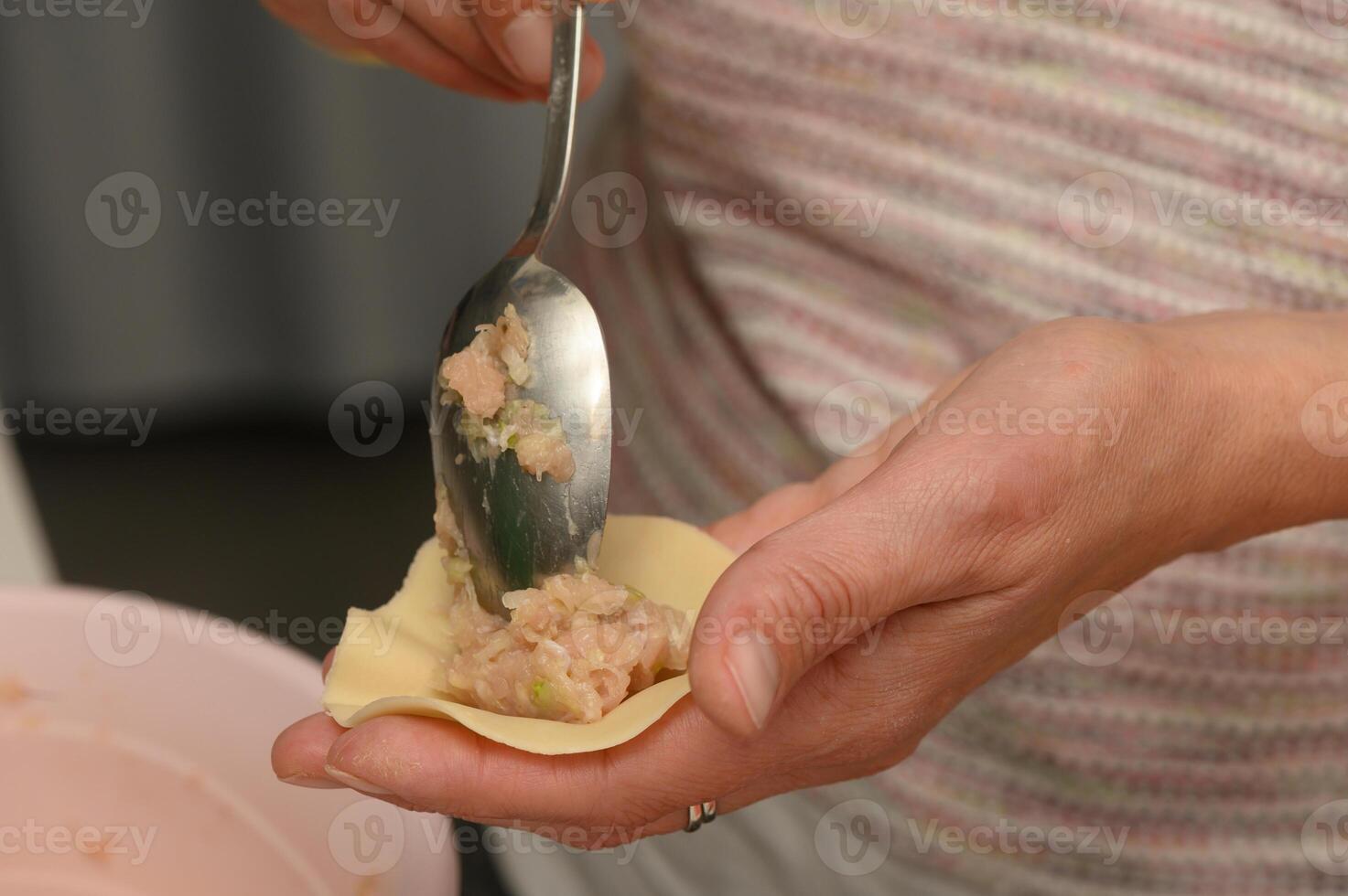 Crafting delicate dumplings filled with savory goodness during a joyful afternoon in a cozy kitchen photo