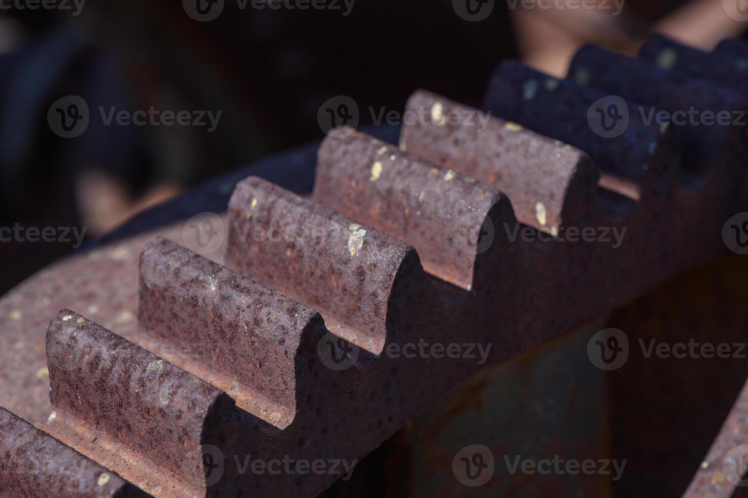 Rustic gears interlocking under a sunbeam in an abandoned industrial landscape photo