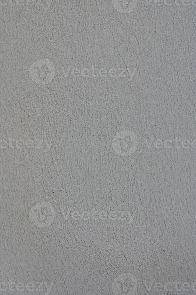 Textured plaster wall exhibiting subtle color variations under natural light, creating a soft and calming atmosphere photo