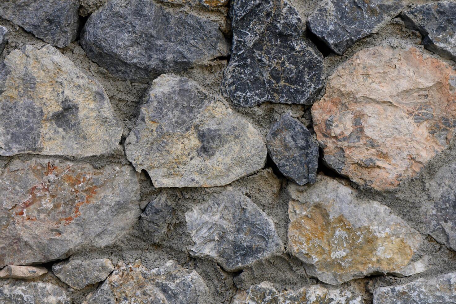 Natural stone wall brings rustic charm to outdoor garden space in sunlight photo