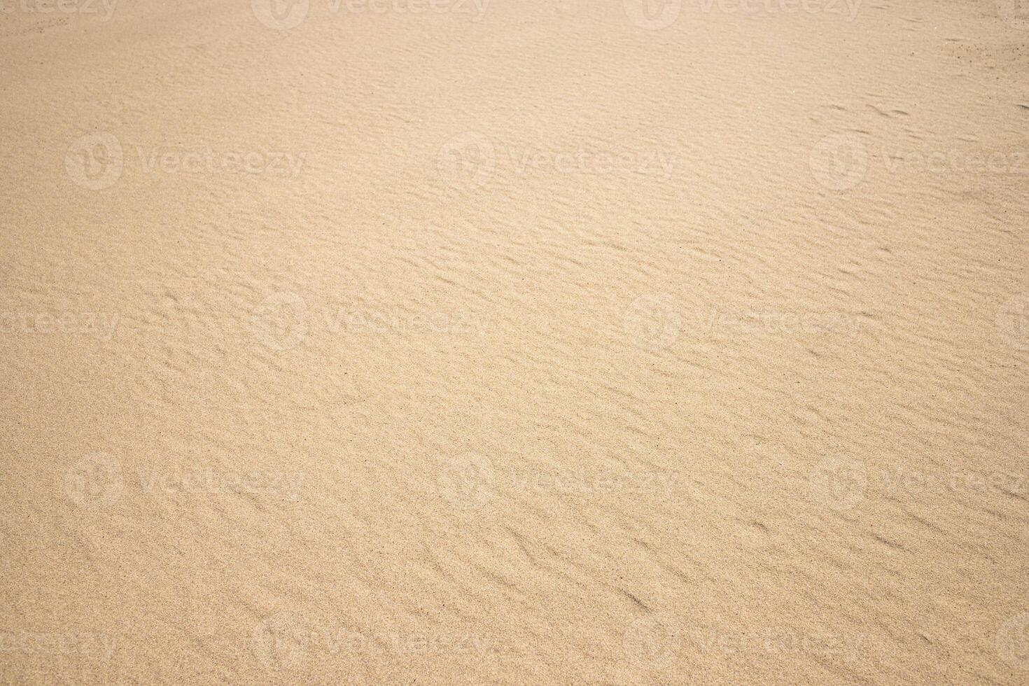 Fine beach sand smooth texture in summer sun close up photo. Nice beige background for your projects photo