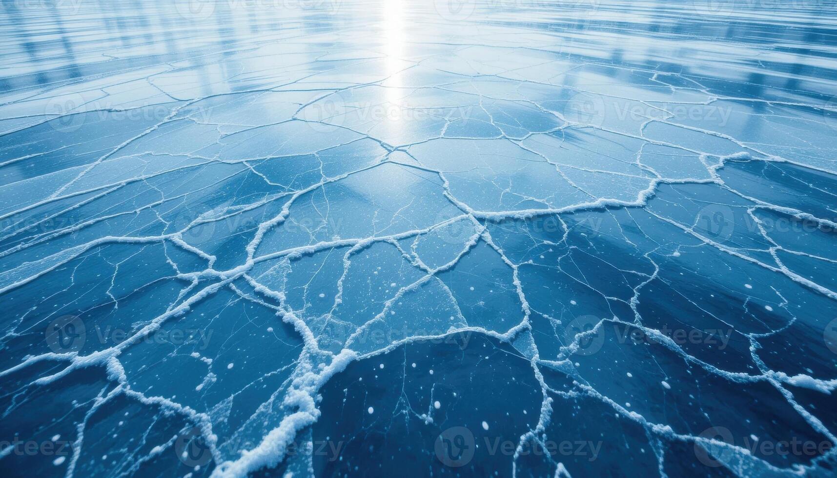 close up of the cracked ice background with a bluish-gray tint and transparent areas. The network of cracks creates a unique pattern that highlights the frosty beauty of winter nature. photo