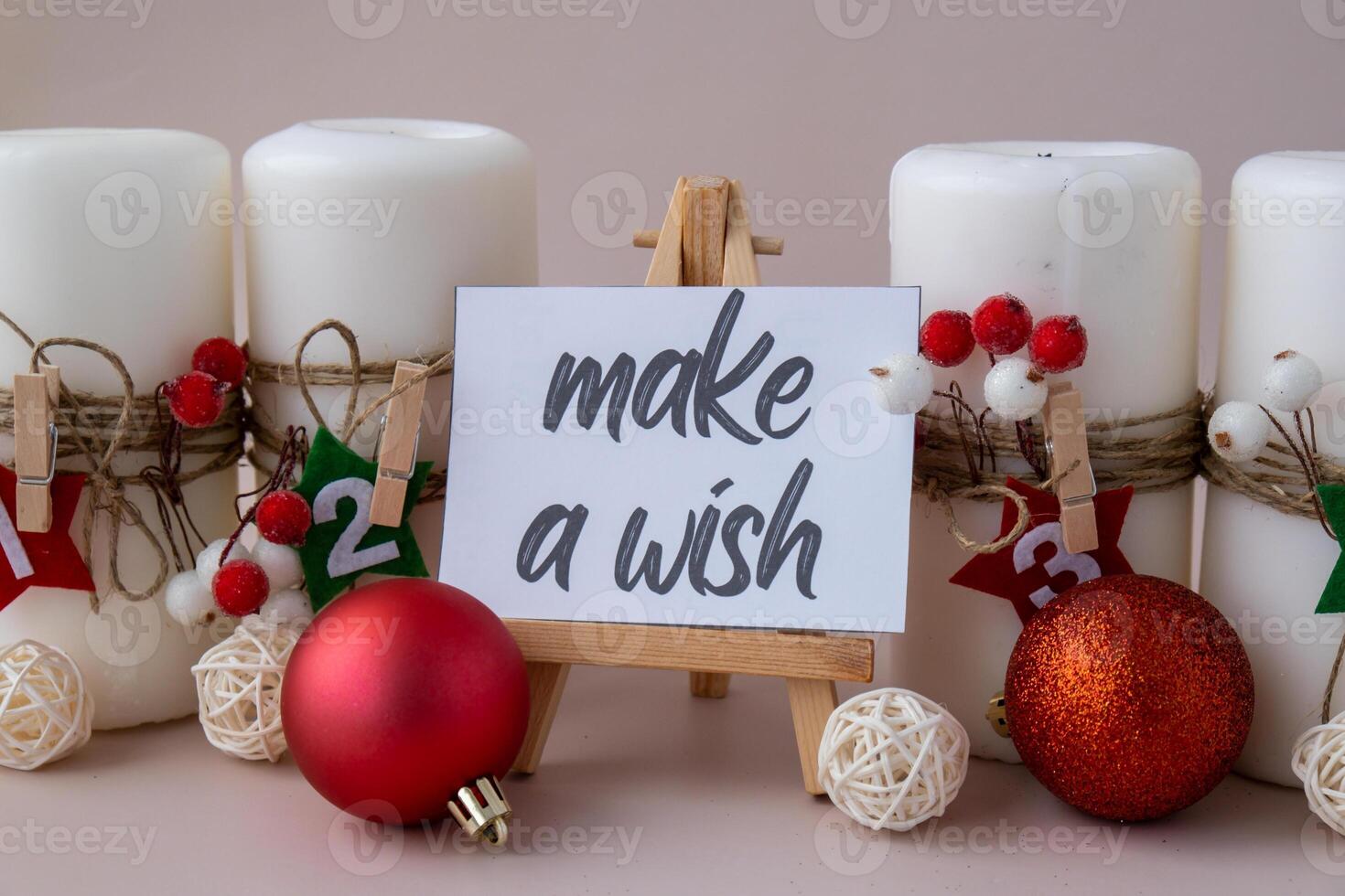 Greeting card with text MAKE A WISH New year and Christmas preparation. Four-week advent candles on table. Handmade eco-friendly decor. Sustainable Christmas decoration. Postcard photo
