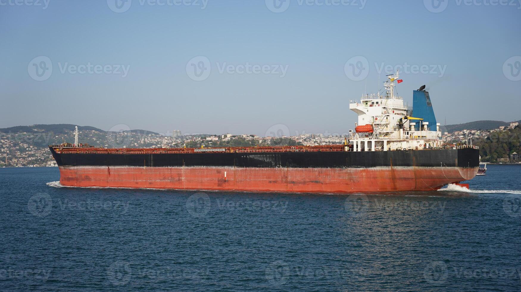 Red and Black Big Cargo Ship in sea photo