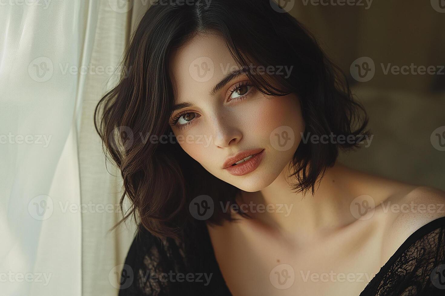 A beautiful young woman with brown eyes and a black lace top photo