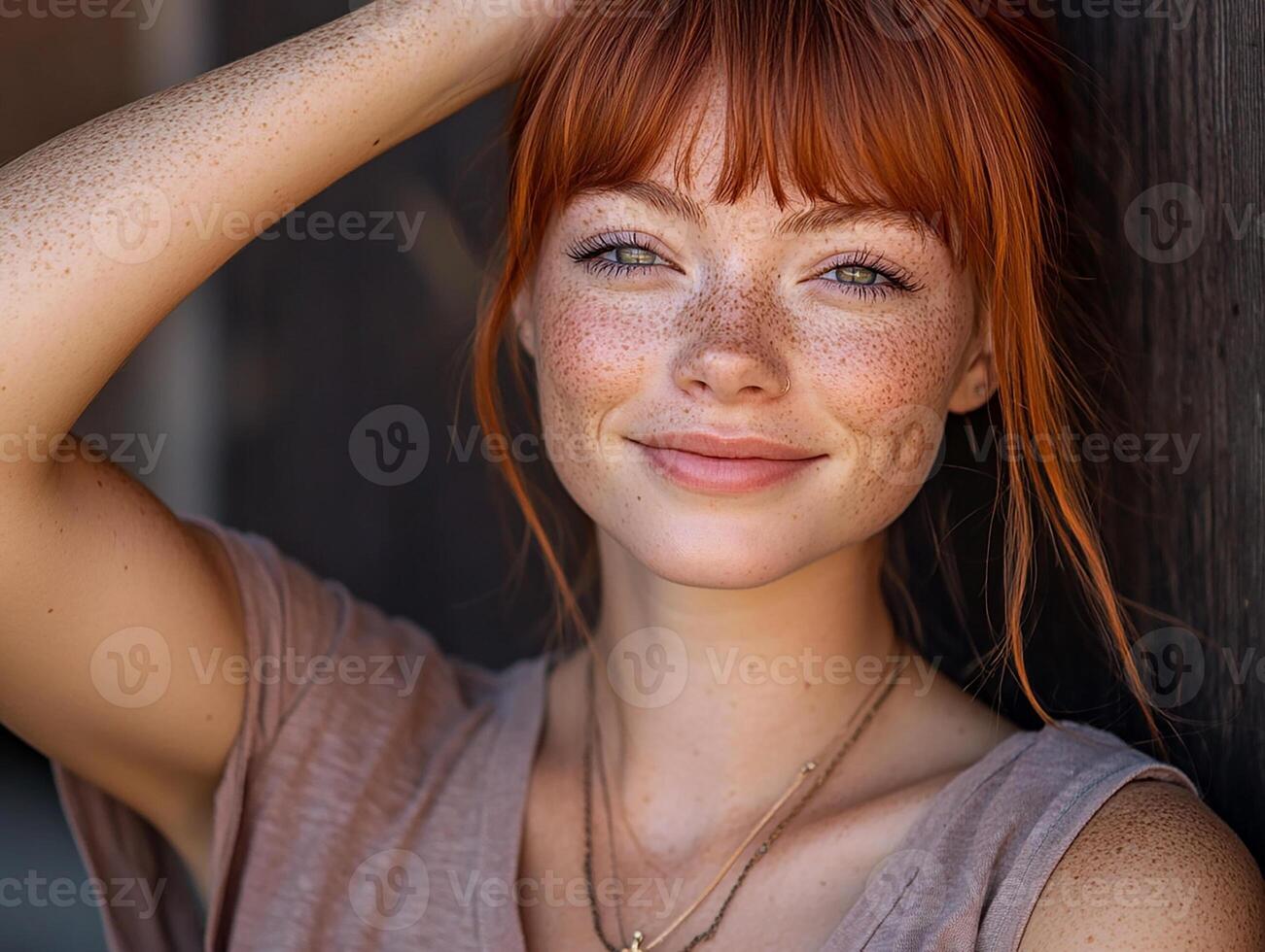A woman with freckles posing for a portrait photo