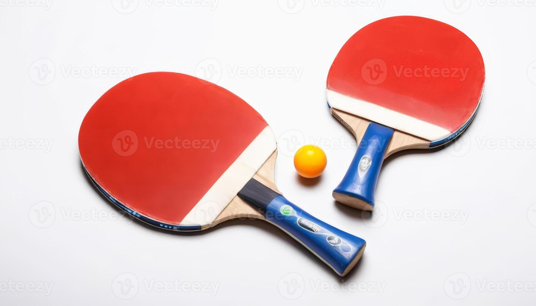 Two red table tennis paddles and a yellow ball are displayed, highlighting the equipment used for a fun indoor sport activity. photo