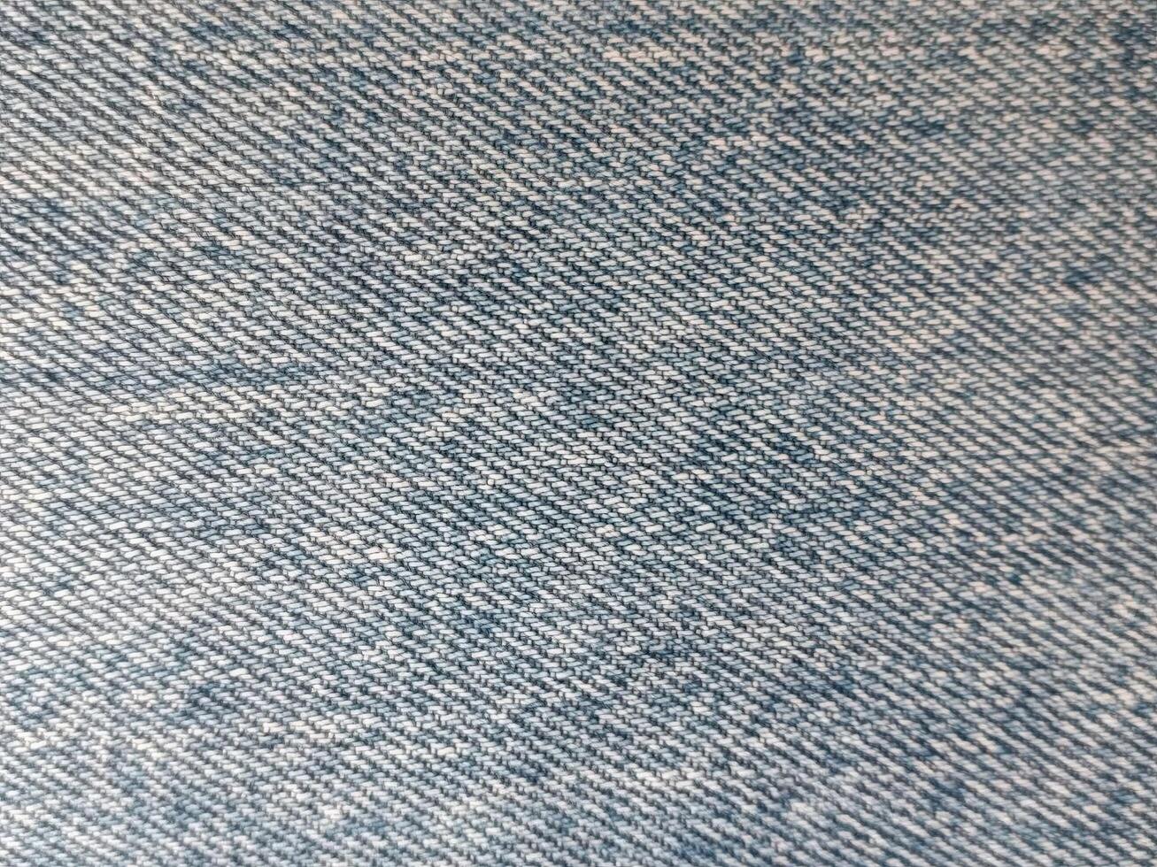 An up-close view of denim fabric showcases its texture and weave, emphasizing its classic and timeless appearance. photo