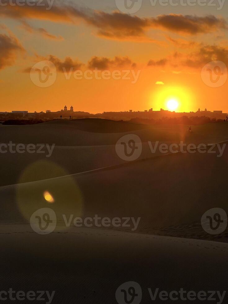 People watching colorful sunset on a Maspalomas dune, Gran Canaria photo