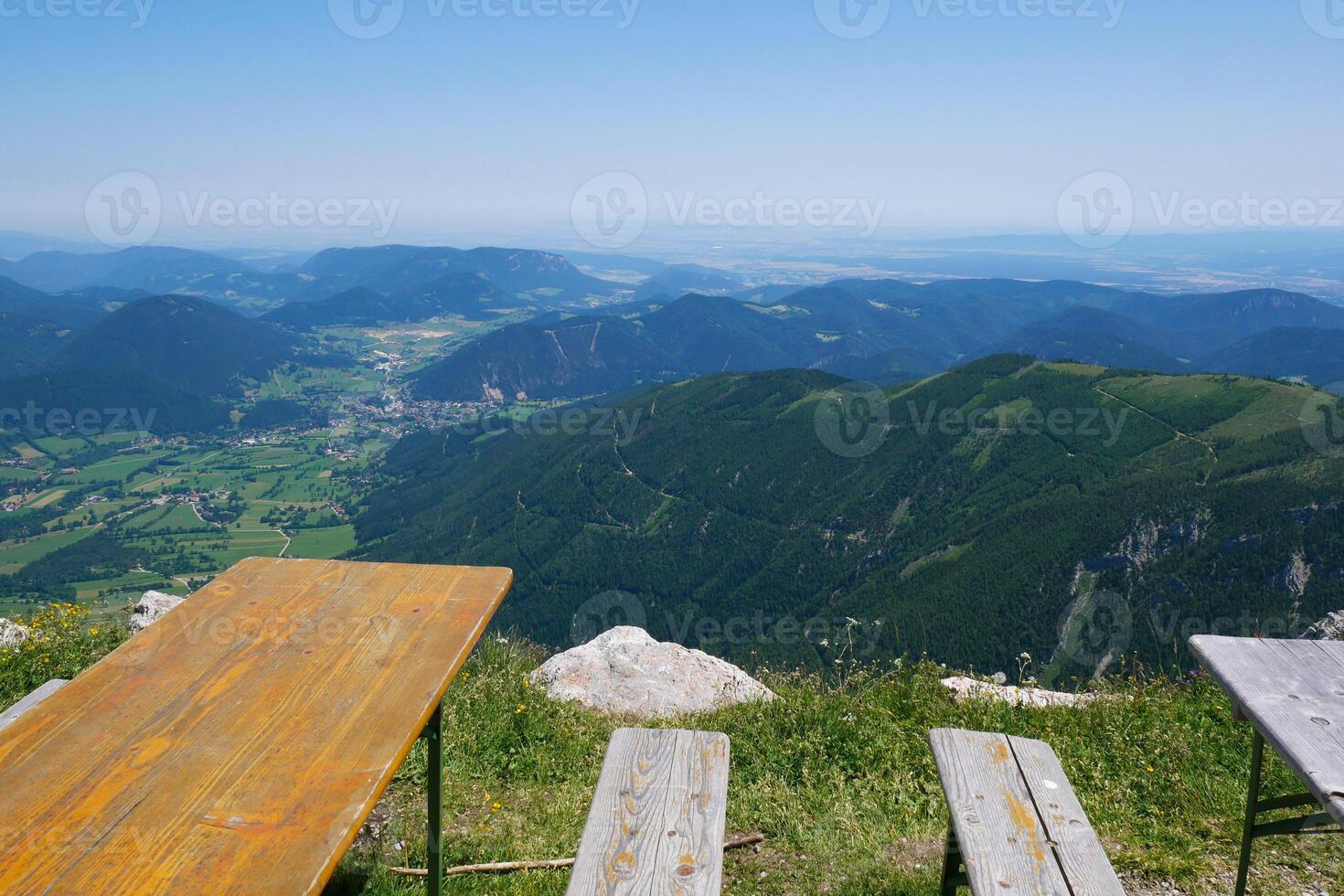 Tables and benches for relaxation, cafe or picnic with a mountain view of Puchberg am Schneeberg, Austrian Alps. Alpine scenery photo