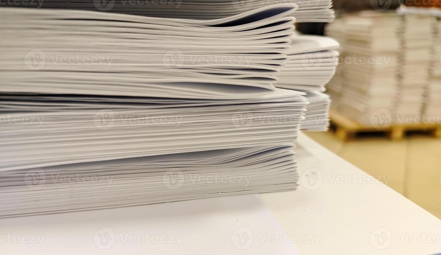 Close-up, a stack of glued book blocks prepared for binding in a printing house, vertical. photo