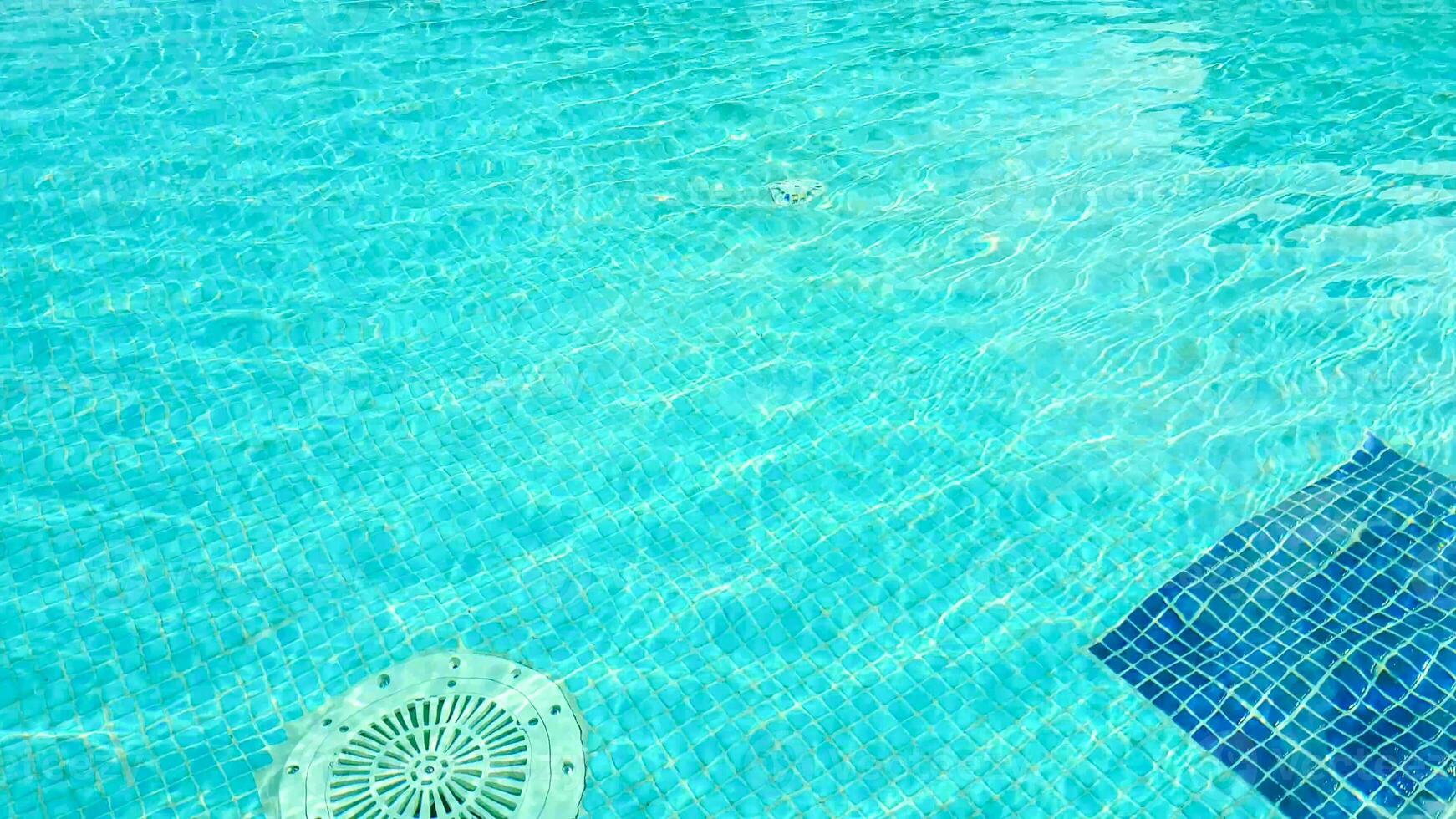 A blue pool with a blue umbrella in it photo