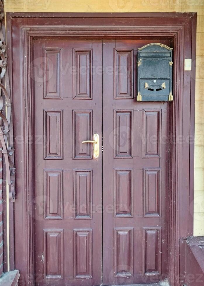 A brown door with a mail box on the side photo