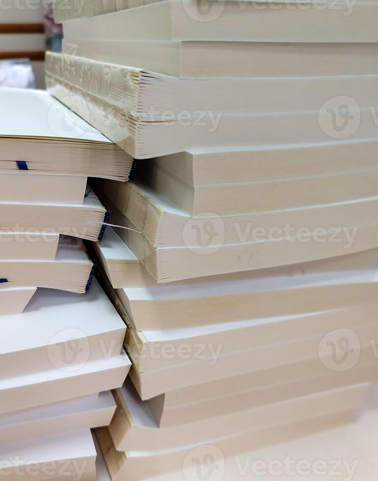A stack of white paper books on a table photo