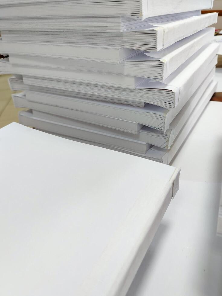 A stack of white paper on a table photo