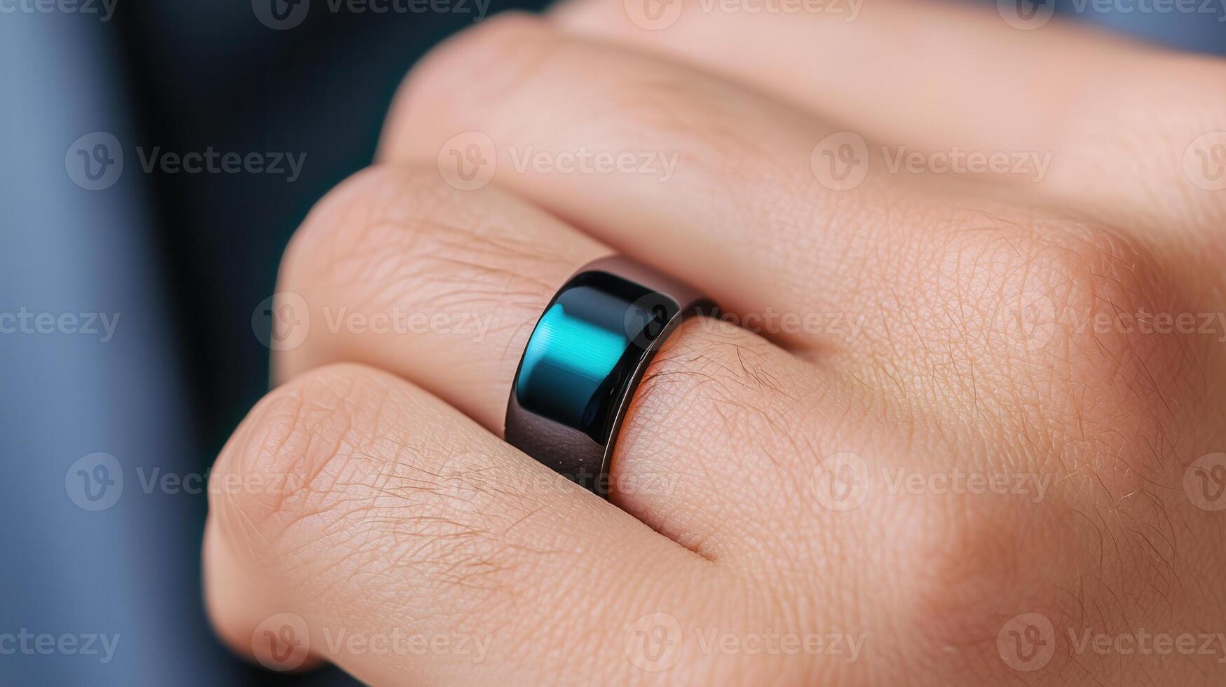 Close up of into hand wearing a sleek, black smart ring, showcasing the integration of technology a everyday accessories photo