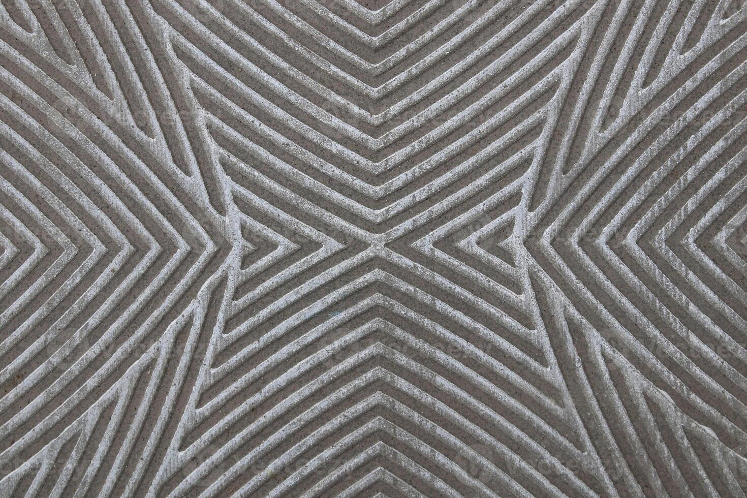 Close-up photograph of floor tiles creating an abstract symmetrical pattern. photo