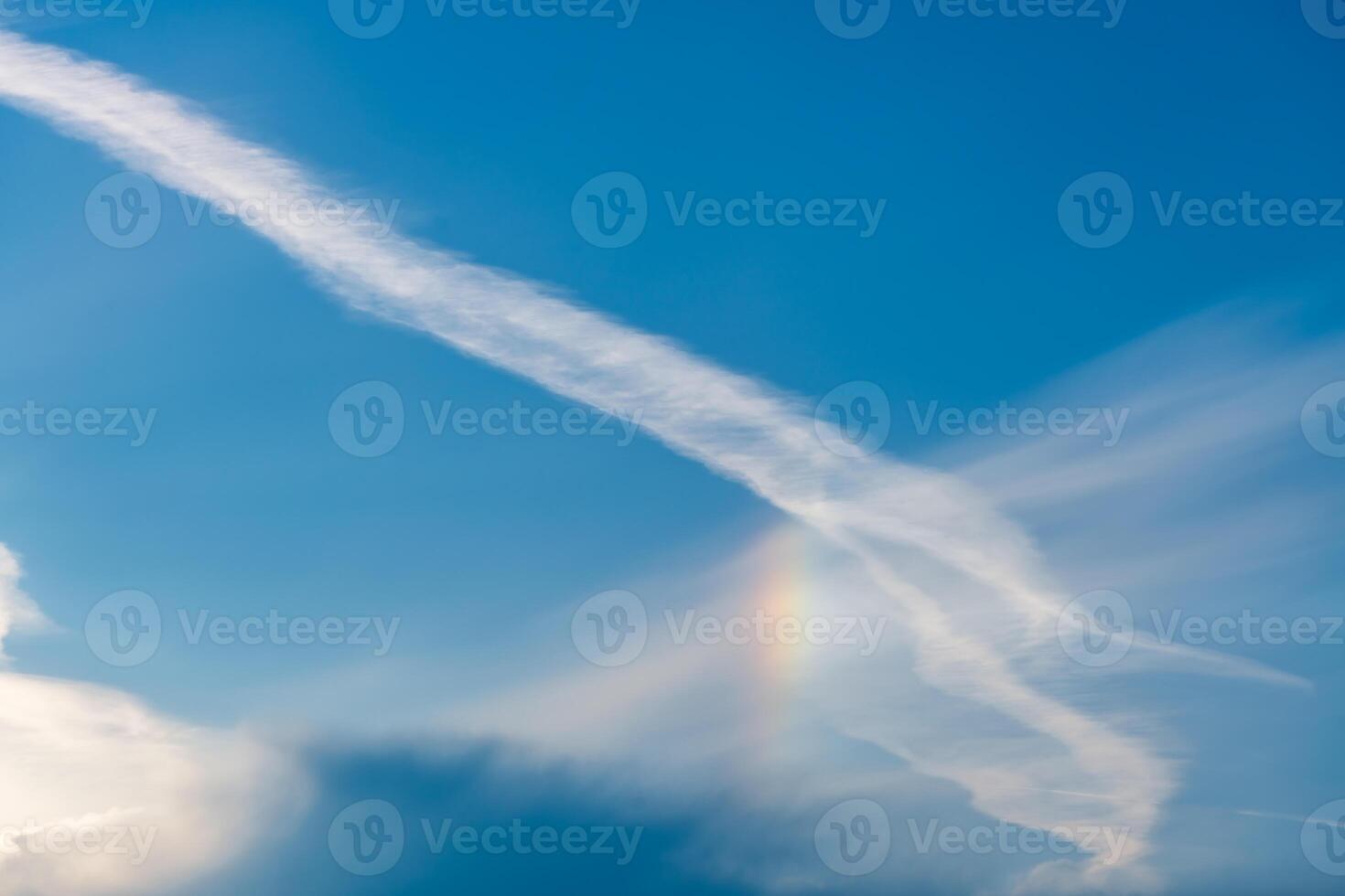 Sky with cirrus, stratus clouds and halo from sun, rainbow photo