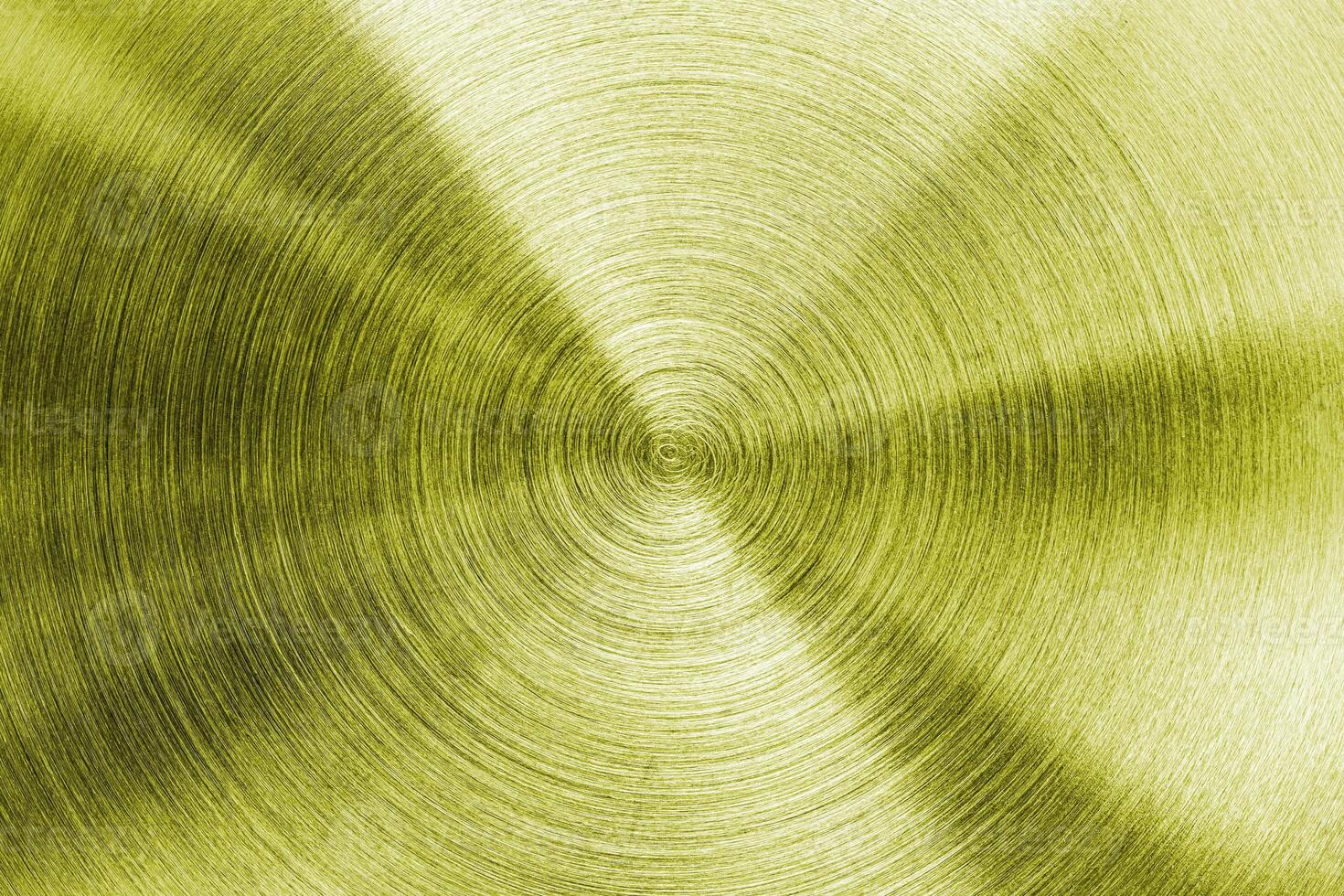A gold metal plate with a circular pattern photo