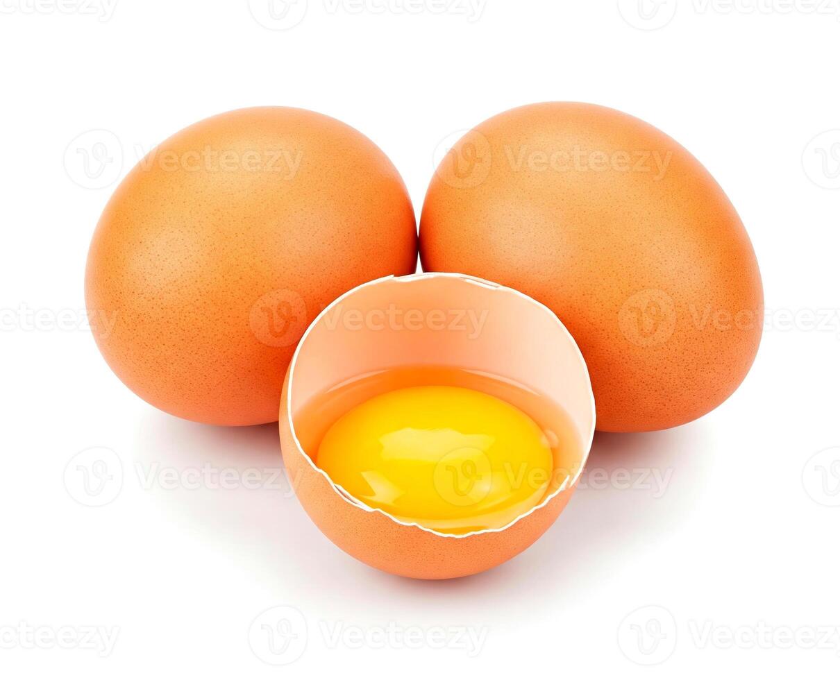 Brown chicken eggs and one broken open egg showing its yolk, isolated on white background photo