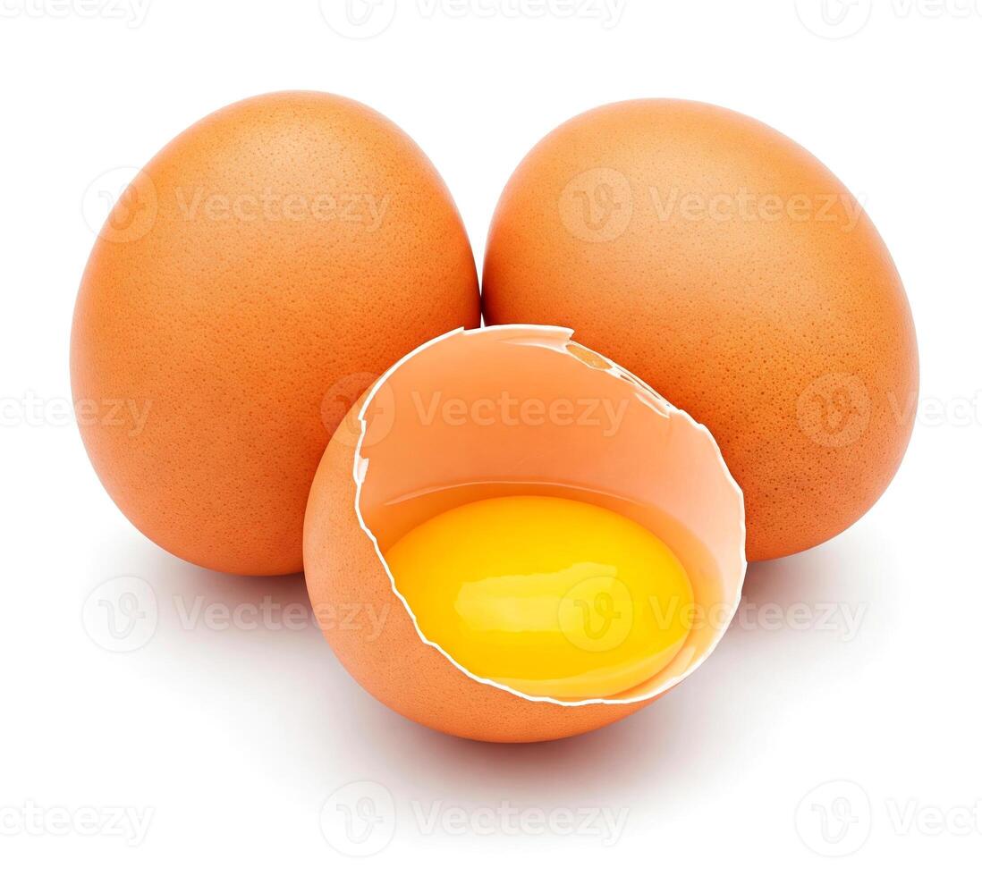 Group of brown chicken eggs and one broken open egg showing its yolk, isolated on white background photo