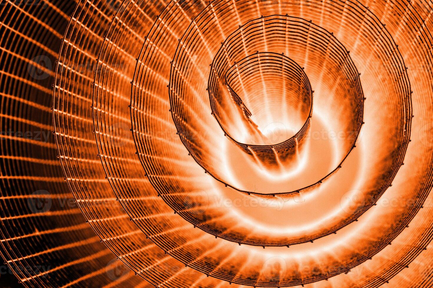 Abstract spiral with glowing red and orange tones and wire texture against a black background, symbolizing energy, motion, industrial and futuristic design concepts. Copy space 01 photo
