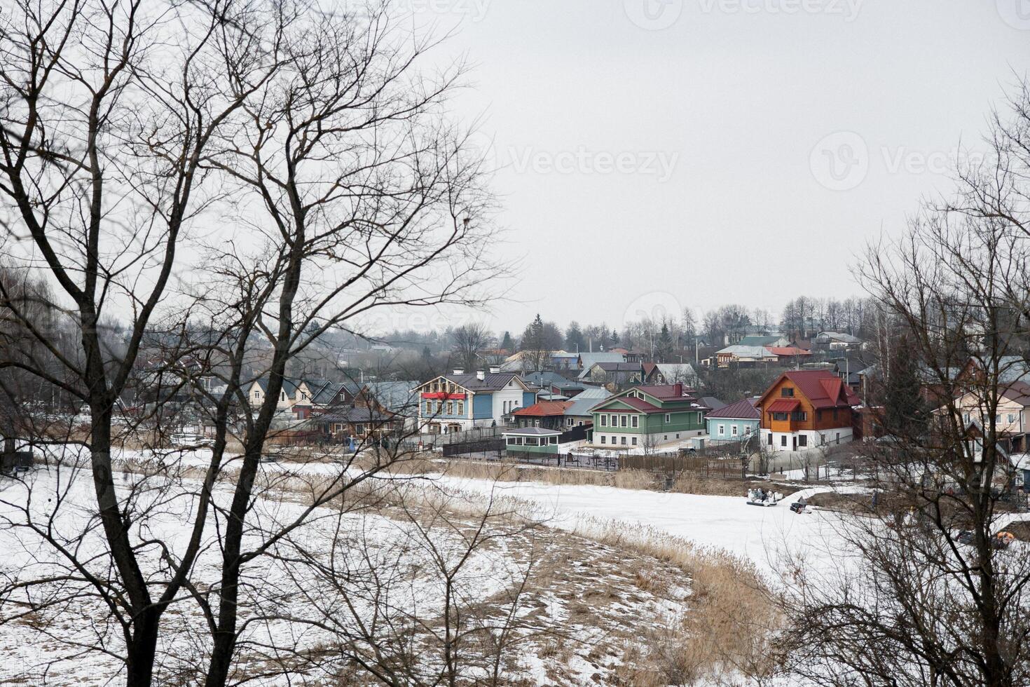 View of the village from above from the hill, frozen river below photo