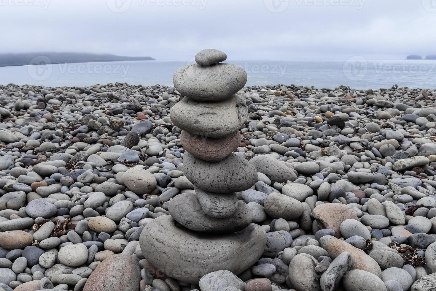Balancing stones creating a zen atmosphere on a pebble beach in Iceland photo