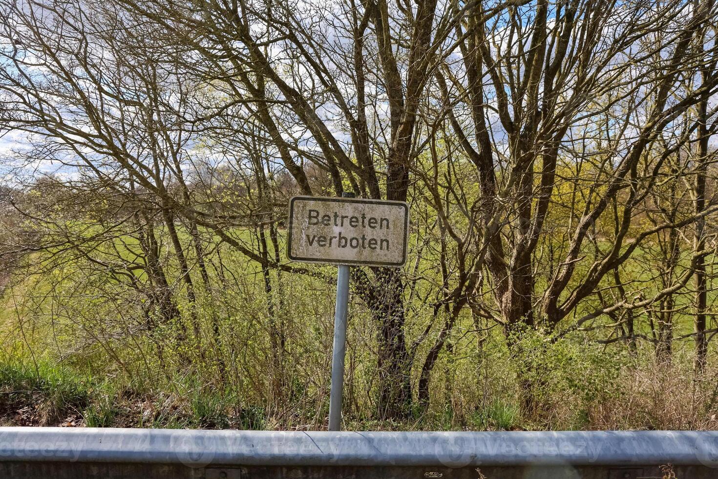 No trespassing sign near a green field in Germany photo
