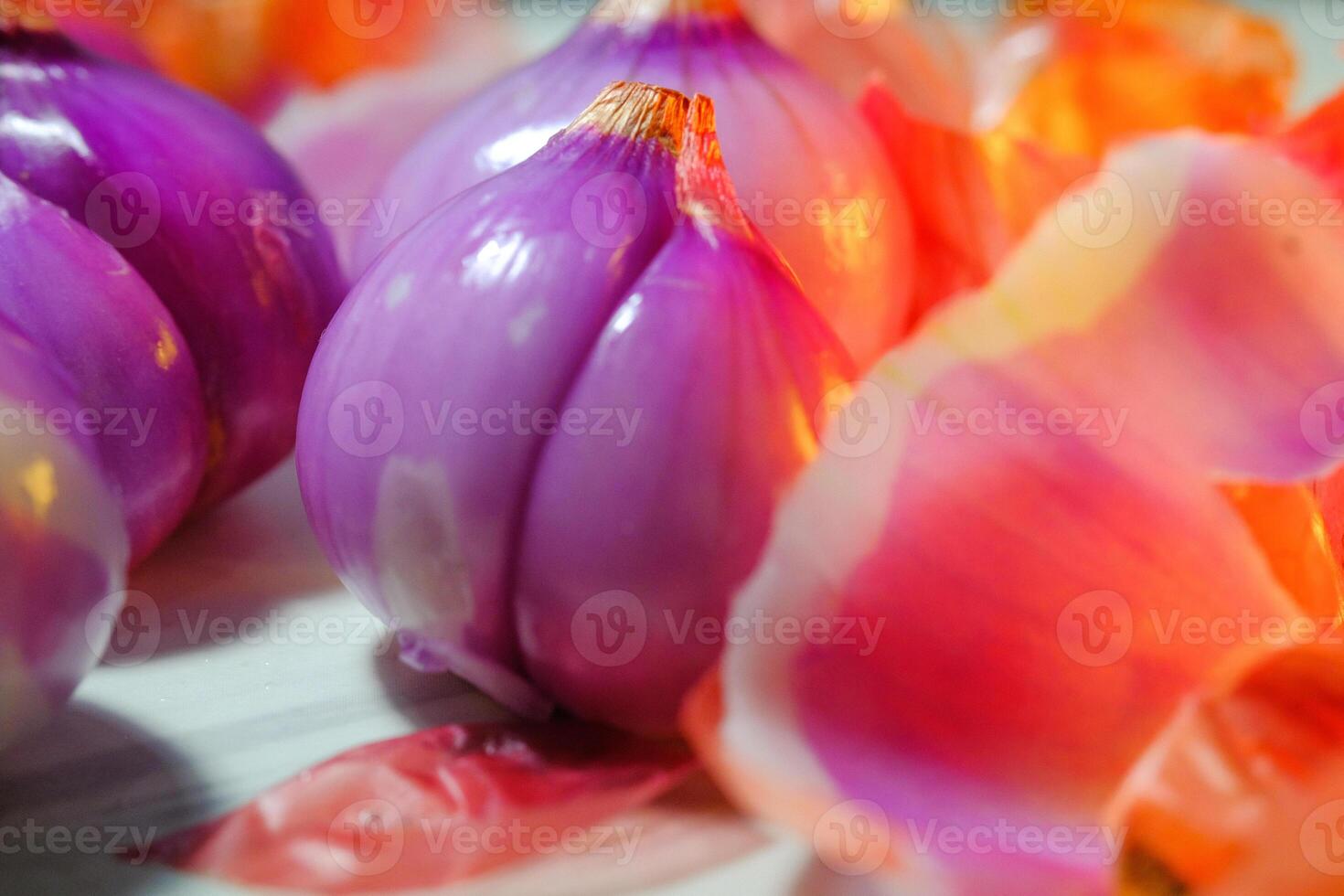 Macro Photography purple shallot close up. Shallot cloves with layered skin. Aromatic tubers with layered membranes. Studio shot. Graphic Resources. Plants Closeup. Copy space photo