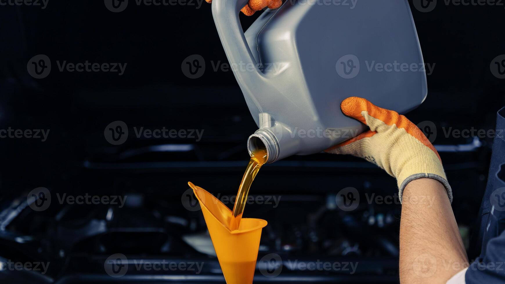 Car mechanic, oil change or fuel from a bottle of engine lubricant, service industry, automobile and engine repair technology. photo