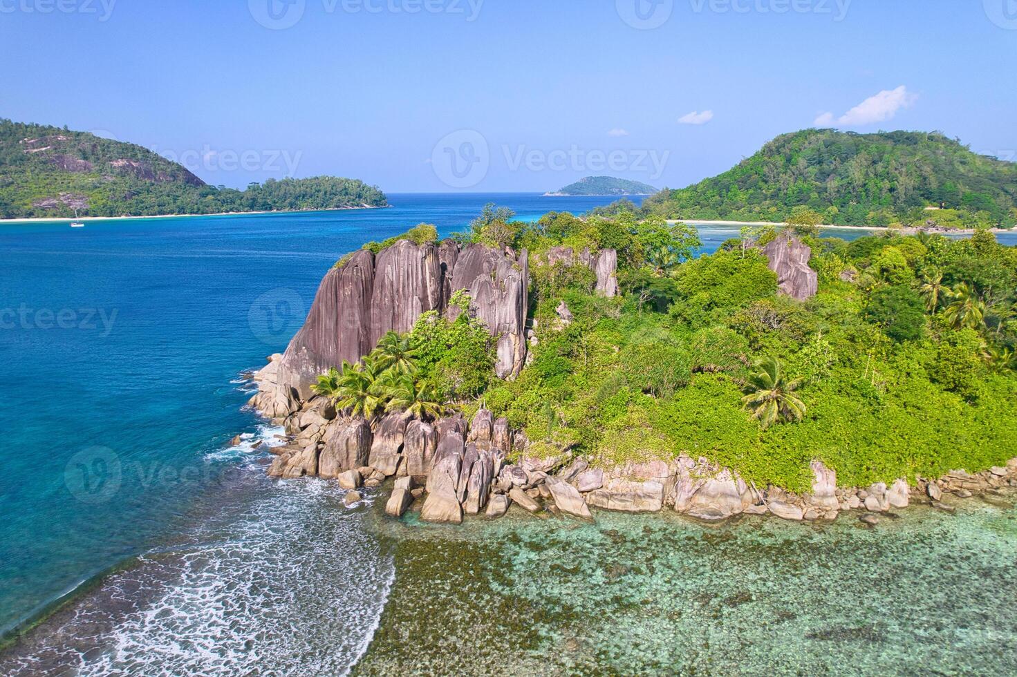Drone shot of port glaud beach, small island nearby shot granite stones, white sandy beach and clear turquoise water, Mahe, Seychelles 2 photo