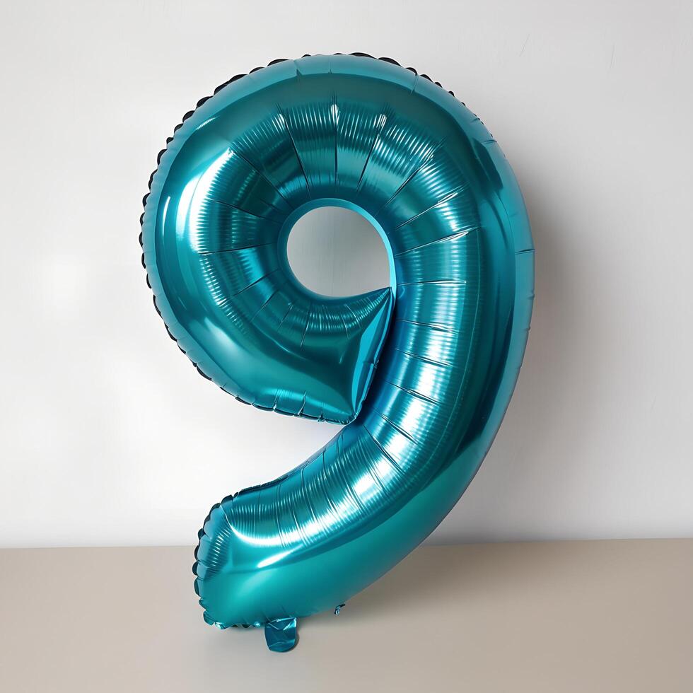 Foil Number Nine Balloon with Turquoise Metallic Sheen on White Surface photo